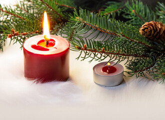 Christmas and New year Holiday Card, Red candle ,  fir tree branches with decorative ornaments on snow