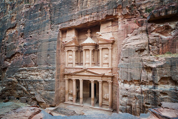 Fototapeta na wymiar ancient treasury in Petra Jordan seen from the Siq. view from the top. main attraction of the lost city of Petra in Jordan. temple is entirely carved into the rock. Ancient old architecture