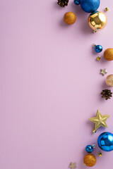 Ring in the New Year with sophistication. Vertical top view of beautifully presented stylish tree ornaments, sparkling balls, stars, pine cones on lilac background, perfect for your greeting or promo