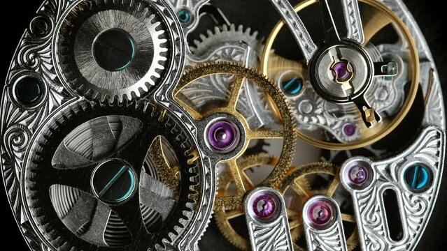 Close-Up of an Antique Pocket Watch's Internal Gears and Moving Springs on Gray