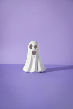 Scary Halloween Ceramic ghost on purple cardboard