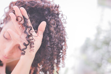 Close-Up of a woman's hand holding a ringlet of hair