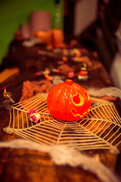 Halloween Jack-O-Lantern decoration on a spider's web
