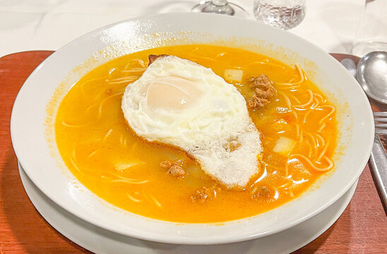 Peruvian noodle soup with meat, egg and vegetables