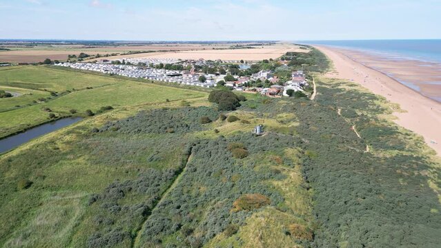 Above the shoreline, video footage captures the serenity of Anderby Creek, a quiet and unspoiled beach in the town of Anderby on the Lincolnshire coast.