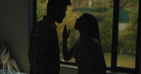 Indian Asian India stress upset tense young wife lies argue fight shout each other at dark indoor home angry sad adult boy man male friend girl bad talk family crisis insult abuse in living room house - Powered by Adobe