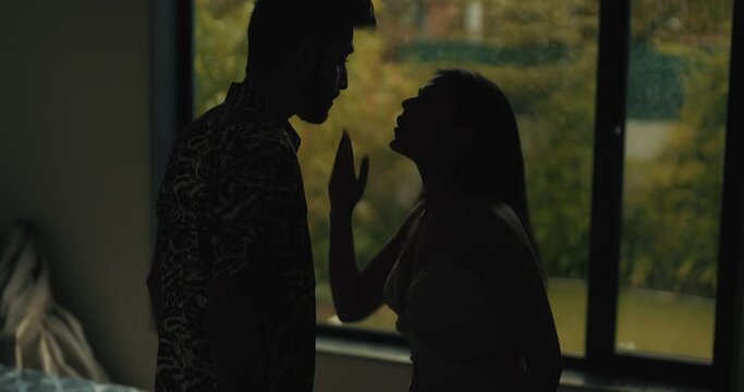 Indian Asian India stress upset tense young wife lies argue fight shout each other at dark indoor home angry sad adult boy man male friend girl bad talk family crisis insult abuse in living room house