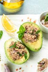 Avocado Stuffed with Tuna Salad, vertical image. top view. place for text
