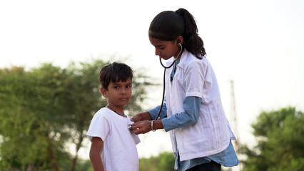 Female doctor or pediatrician with stethoscope listening to heartbeat boy's patient on medical exam...
