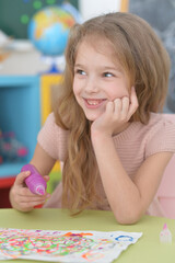 Portrait of cute girl drawing picture at home