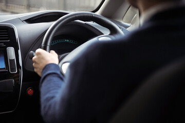 Car driving background. Steering wheel with driver's hands