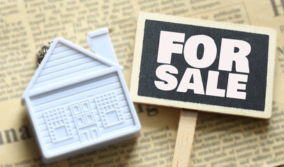 FOR SALE words on a small board. House or apartment for sale.