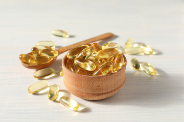 Omega pills in a wooden bowl on a white background