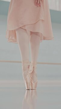 Close Up of Ballerina Feet in Pointe Shoes Dancing Gracefully. Female Classical Ballet Dancer Performing her Choreography. Vertical video format for the phone.