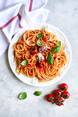 Spaghetti with grilled tomatoes. Top view with copy space.