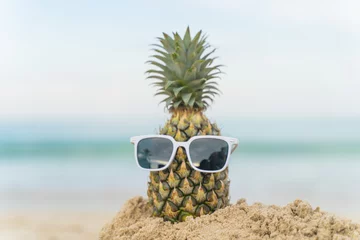 Gordijnen Fruit man made of pineapples on the beach fruit tourism for health Funny and cute sunbathing fruits. Festive food. Summer travel concept. white background design invitation to visit copy space © Stock.Foto.Touch