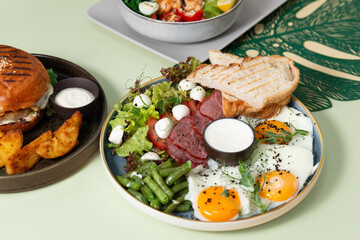 fried eggs with bacon and vegetables close up, healthy lunch