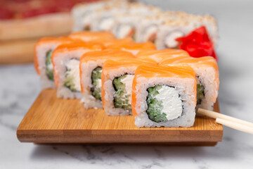 set of sushi rolls on wooden desk close up