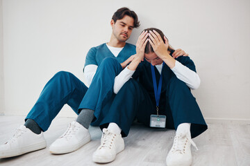 Crying doctors, clinic floor and woman with man, support or empathy for regret, death or fail in...