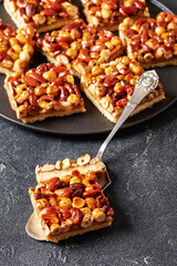 toffee mixed nuts shortbread bars on black plate