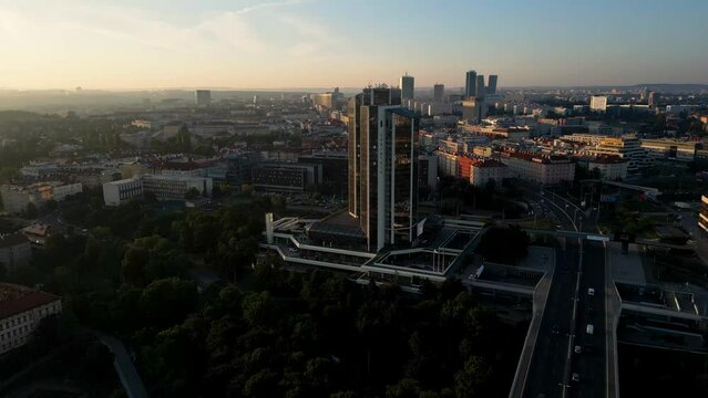 Drone is flying around a tall office building, modern architecture, Prague, 4k