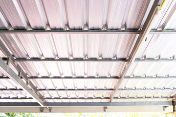 Underneath structure is gray aluminum roof house, home sheet with steel beam. Corrugated metal...