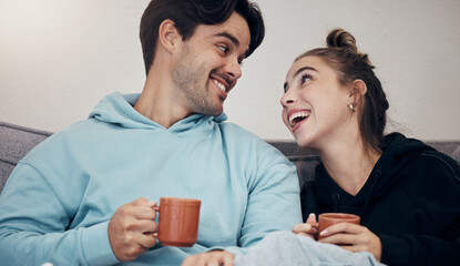 Couple, coffee and relax with smile, love and trust on sofa in living room of home or apartment with bonding. Tea, man and woman together with happiness for peace, romance and commitment on couch