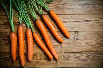 Fresh carrots on wooden table.