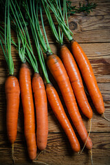 Fresh carrots on wooden table.