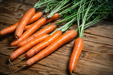 Fresh carrots on wooden table.