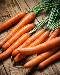 Fresh carrots on wooden table.