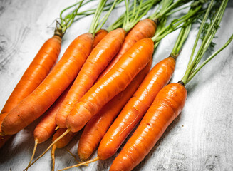 Fresh carrots on wooden table.