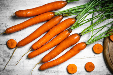 Fresh carrots on wooden table.