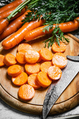 Fresh chopped carrots on cutting board.