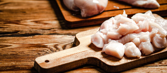 Sliced chicken fillet. On cutting board.