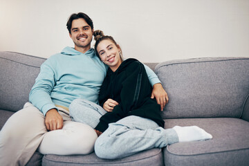 Portrait, relax and smile with a couple on a sofa in the living room of their home together for bonding. Love, hug or date with a happy man and woman in their apartment for romance or relationship