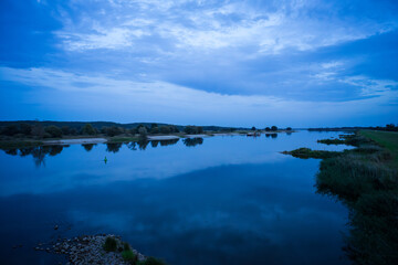 Evening natural landscape on the Oder River. Border of Germany and Poland.