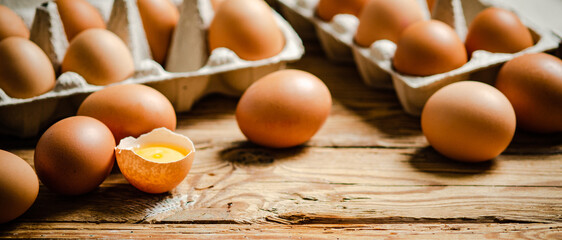 Chicken eggs on wooden table.