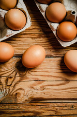 Chicken eggs on wooden table.