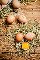 Chicken eggs on wooden table.