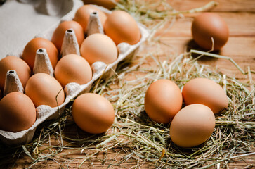 Chicken eggs on wooden table.