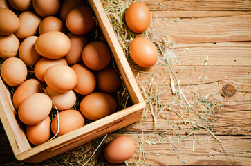 Fresh chicken eggs in old box.