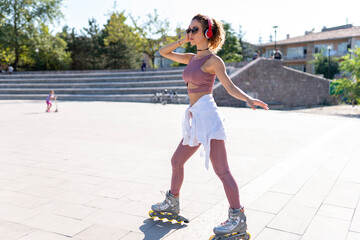 Young woman inline skating in a park