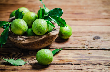 Fresh limes. On wooden table.
