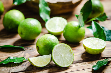 Fresh limes. On wooden table.