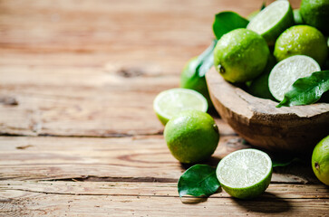 Fresh limes. On wooden table.