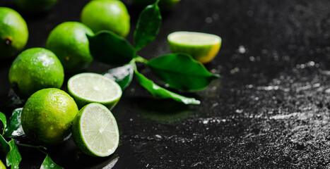 Fresh limes. On black table.