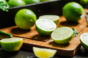 Fresh limes. On black table.