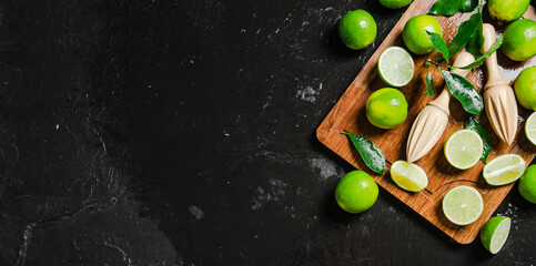 Fresh limes. On black table.