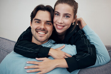 Portrait, hug and smile with a couple on a sofa in the living room of their home together for bonding. Relax, love or date with a happy man and woman in their apartment for romance or relationship